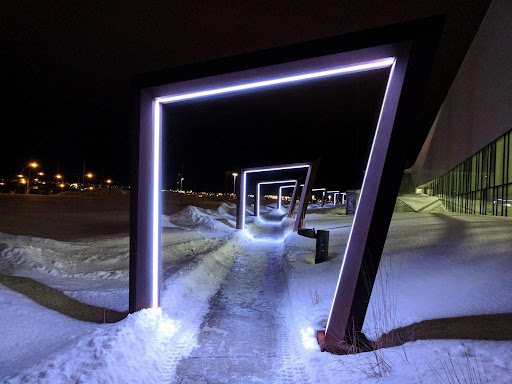 Neon-framed gateway portal in snowy landscape